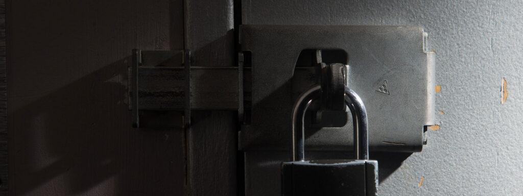 Players attempting to crack a safe inside the Bank Job escape room at Fox in a Box Hong Kong.
